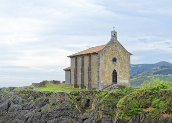 Chapel of Santa Katalina on a rocky promontory in the Basque fishing town of Mundaka in Northern Spain