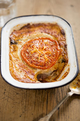 Lamb moussaka with slice of tomato 