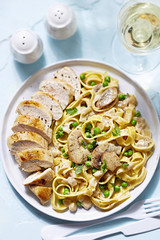 Chicken breast with pasta in mushroom and peas sauce