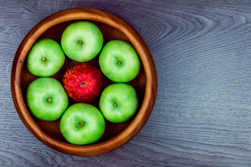Healthy food. Several apples in the wooden plate isolated on grey background. Making apple pie