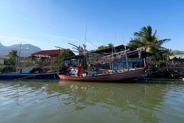 Fototapeta na wymiar A wooden fishing boats on front of a traditional village, Thailand