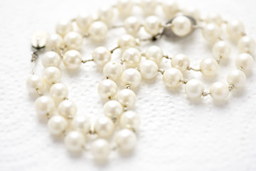 White pearls on white background