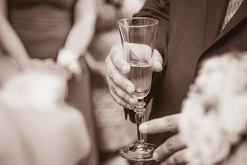 Man in suit holding a glass 