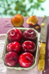 Fresh plums on wooden table 