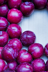 Fresh plums on wooden table 