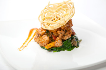 Fried chicken in sweet and sour sauce with french fries.