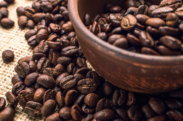 Coffee beans in wood bowl on white background