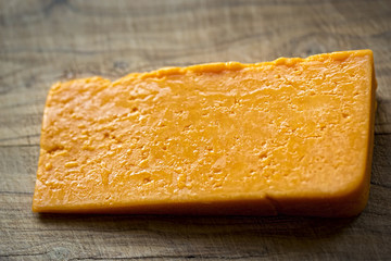 Red cheddar on wooden board 