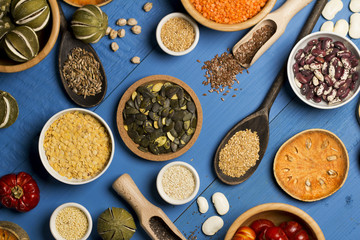 Various dried legumes in bowls for background, Raw legume on old rustic wooden table, Healthy protein food. Place for typography, top view