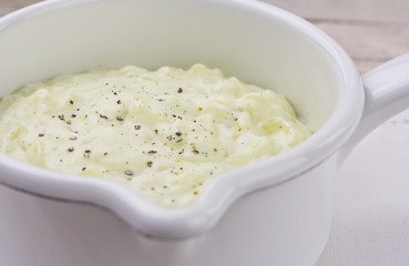 Vanilla rice pudding in white enamel pot