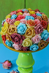 birthday cake with colorful roses made of modelling chocolate and fondant on green cake stand, spring, love, romance concept