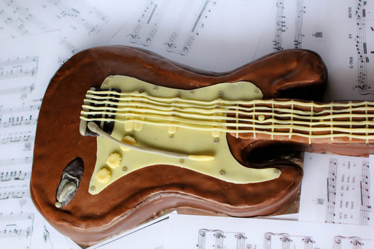cake in shape of a guitar made of modeling chocolate