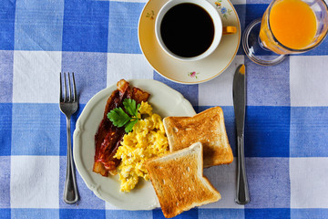 scrambled eggs with toast and bacon, english breakfast