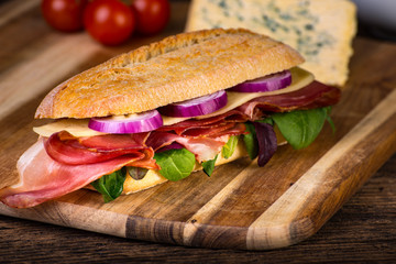 Long sandwich with sausage, chees and lettuce