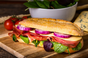 Long sandwich with sausage, chees and lettuce