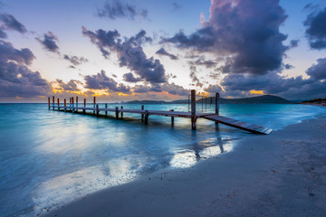 Obraz premium Wooden pier in the Mediterranean Sea, Alghero, Sardinia, Italy