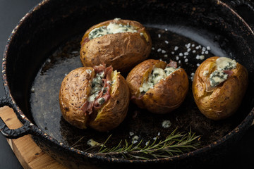 Baked potatoes with prosciutto and chees