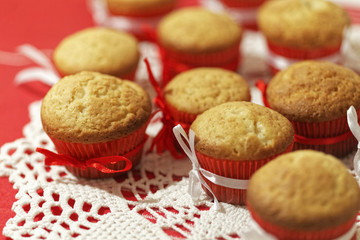 Homemade cupcakes on a red background. Festive bakery.