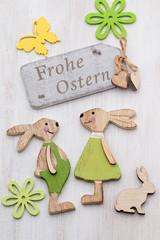 Spring and Easter decor. Wooden symbols bunny, flowers and butterflies.