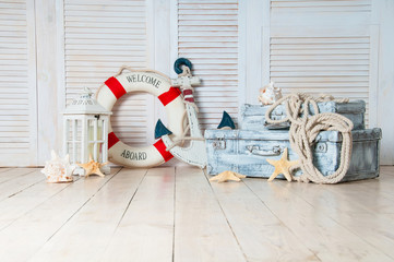 Decor in the style of sea travel, Suitcases and anchor, lifebuoy, lantern