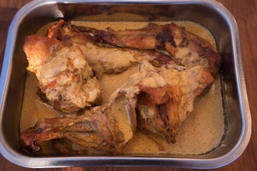 Roasted or baked rabbit meat in dijon mustard sauce in the shallow stainless steel pan. Typical exapmle of the French rustical cuisine, all ingredients are fresh and without any additives.