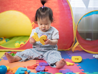baby girl learning alphabet blocks