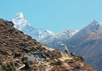 Tourists on the track near of peak Ama Dablam in Nepal
