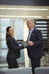Fototapeta premium Business executives standing while holding a clipboard