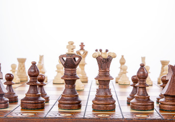 Chess on a wooden board on a white background