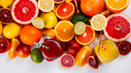 Fototapeta na wymiar Juices Fresh Orange and Citrus on a White Background.Healthy Beverage.Food or Healthy diet concept.Mixed Colorful Tropical Background.Copy space for Text. selective focus