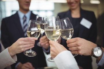 Businesspeople toasting glasses of champagne - Powered by Adobe