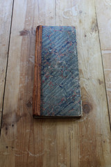 Vintage ledger with marbleized paper cover, straight on the table
