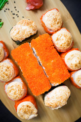 Japanese food - sushi rolls and sauce on a black background. Top view. Flat lay