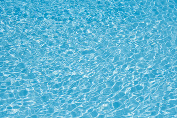 Blue and bright ripple water and surface in swimming pool , Beautiful motion gentle wave in pool