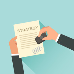 Businessman approving a paper with Strategy headline. Hand with approved stamp. 