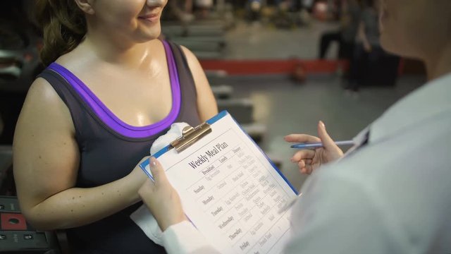 Healthy nutrition expert making weekly meal plan for client, weight loss program