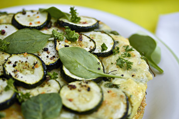 Tortilla with courgettes and spinach leaves