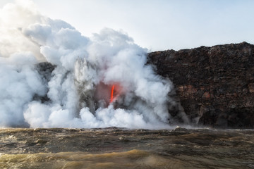 Fototapeta na wymiar Violent explosions from hot lava entering cold water at Kamokuna Entry, Hawaii