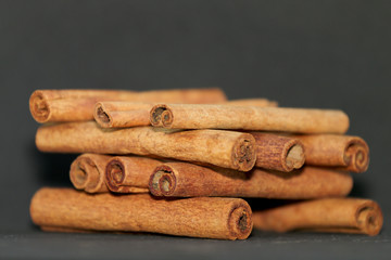 cinnamon sticks placed out on a black background