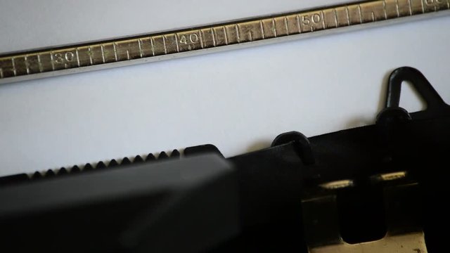 Typing the expression GUILTY with an old manual typewriter