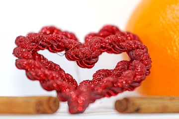 Two hearts red bark cinnamon, orange background, Valentine's Day,