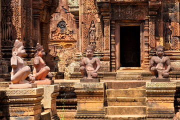 Banteay Srei temple, Angkor, Cambodia. Statues of human figures with animal heads, guardians at the...