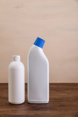 Mock-up plastic bottles. Mockup design for branding. Shampoo and washing wc cleaner. Front view. Wooden rustic board.