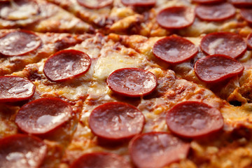 Pepperoni pizza. Hot homemade food. Sliced fresh italian classic salami pizza. Popular topping with cheese. Baked meal.