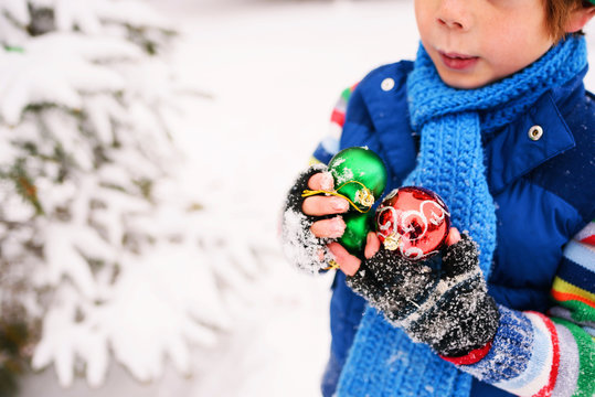 Boy holding Christmas decorations