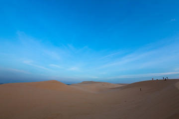 Fototapeta na wymiar Group of people on white sand dunes - Mui Ne, Vietnam