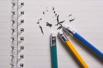 pencil eraser removing a written mistake on a piece of paper, delete, correct, and mistake concept.