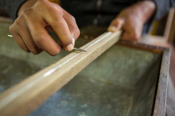 Closeup of silver worker making a chain