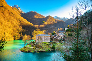 Isola Santa medieval village, church and lake. Garfagnana, Tuscany, Italy. - obrazy, fototapety, plakaty
