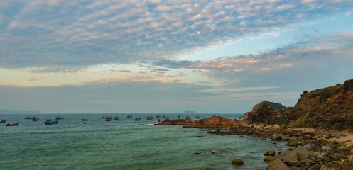 A rocky coastline looking out over the south China sea in Vung Lam Bay Vietnam. With a beautifully cloud formation at sunset.